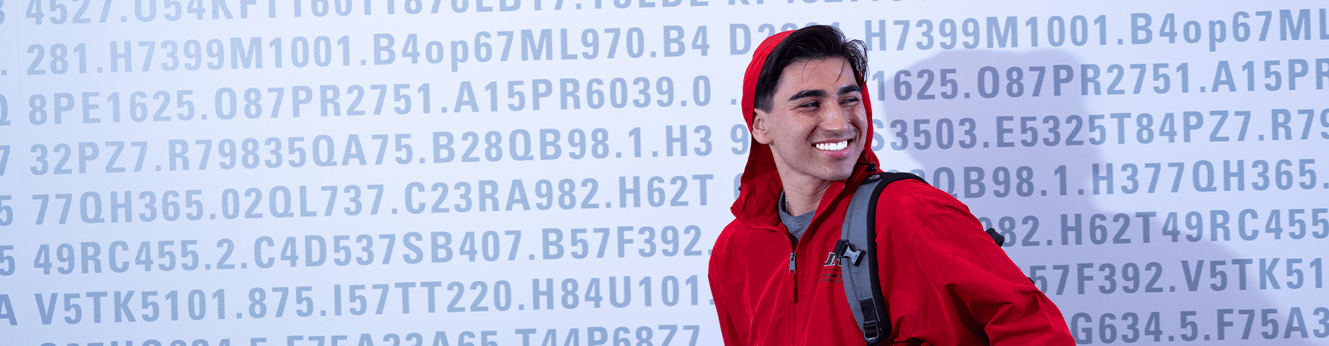 Student wearing red sweatshirt with UHV logo