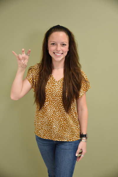 UHV student doing the jaguar hand sign