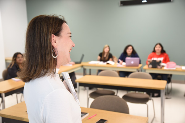 Instructor showing book to students in class