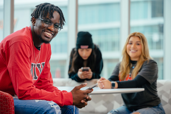 Three UHV students sitting in UHV Commons