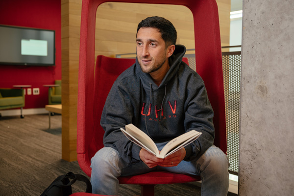 Student sitting in the UHV library with a book