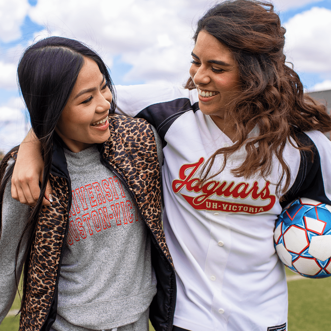 Students smiling on the soccer field