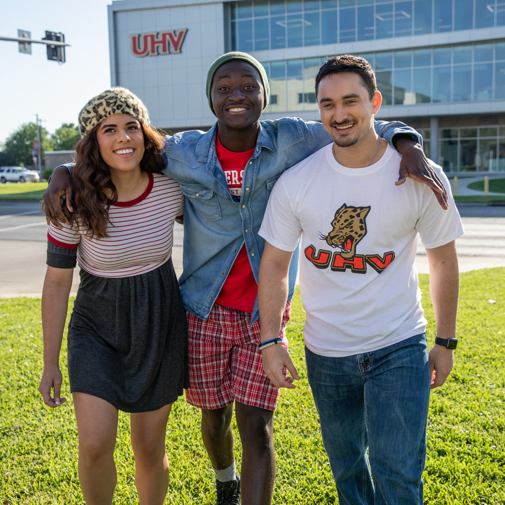 Three UHV students walking away from Commons