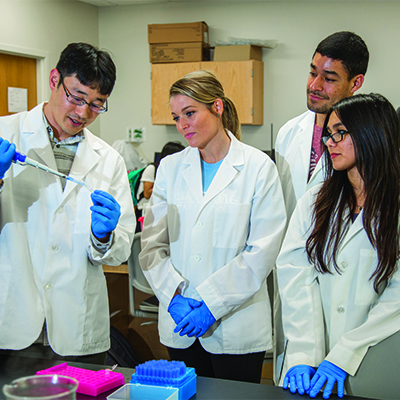 Professor teaching Students in laboratory.