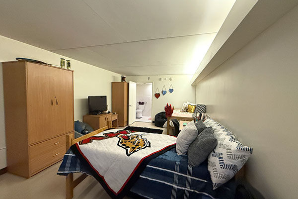 A view of the inside of one of the rooms located in Jaguar Hall showing the sleeping and common area of the room.