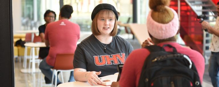 2 Students sitting at a table