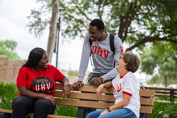 3 Students sitting on a bench