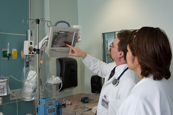 Two medical professionals looking at a monitor