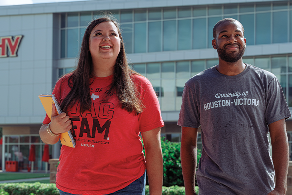 Two students walking outside University Commons.