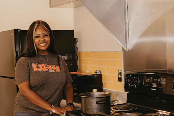 A student in a dorm common kitchen.