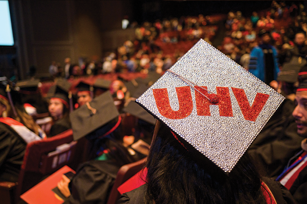 A students graduation cap decorated with the UHV logo.
