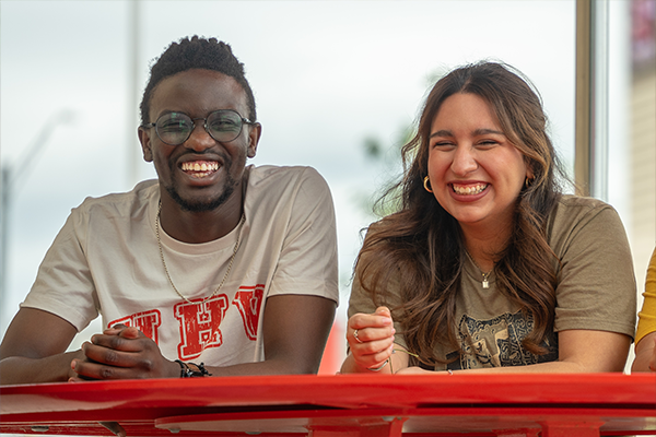 2 students sitting and smiling