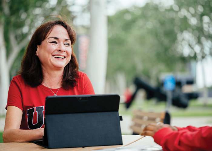 person sitting outside with a laptop