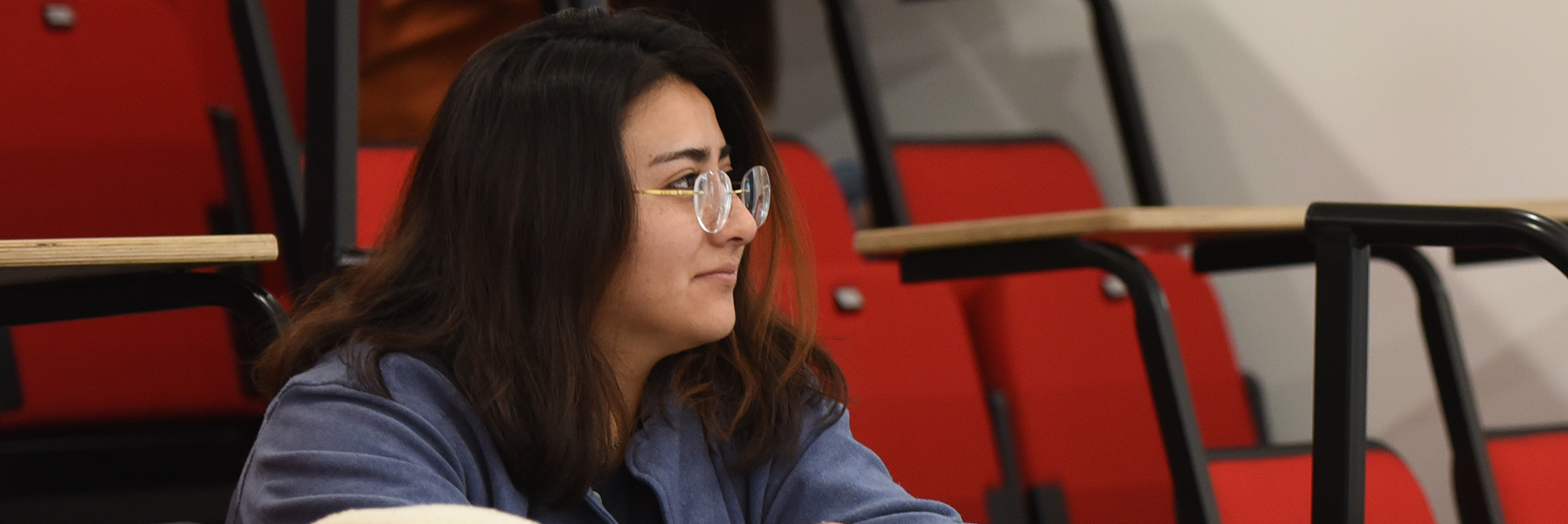 A female student sitting in class.