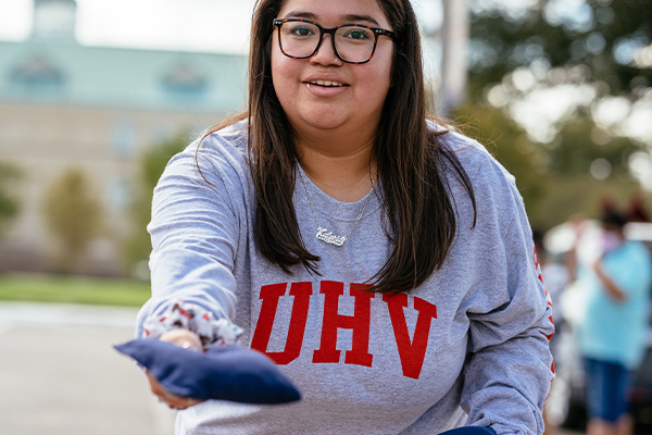 student outside wearing a UHV sweatshirt