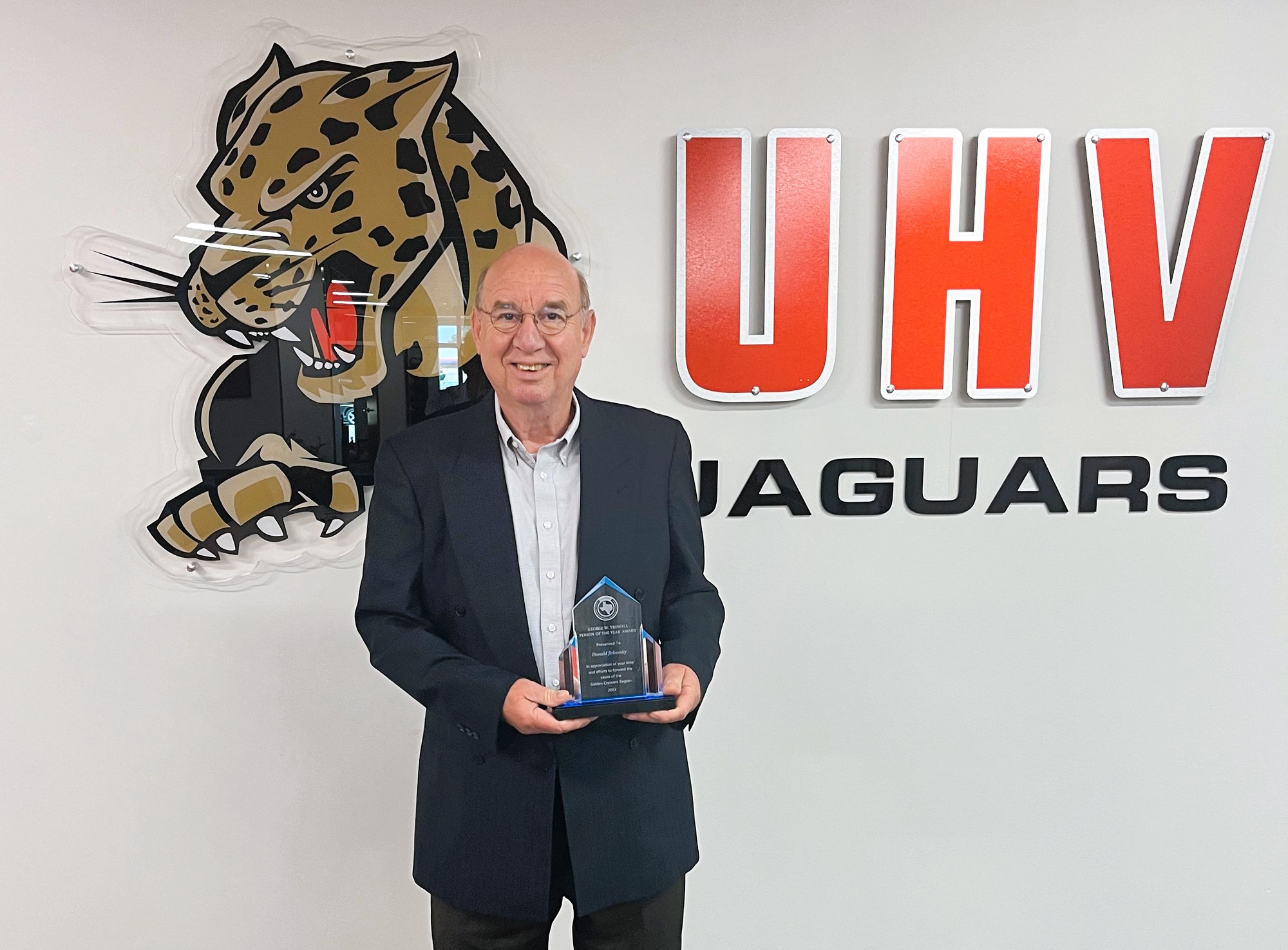 Donald Jirkovsky, the director of the University of Houston-Victoria Center for Regional Collaboration, holds his George W. Trowell Person of the Year Award.