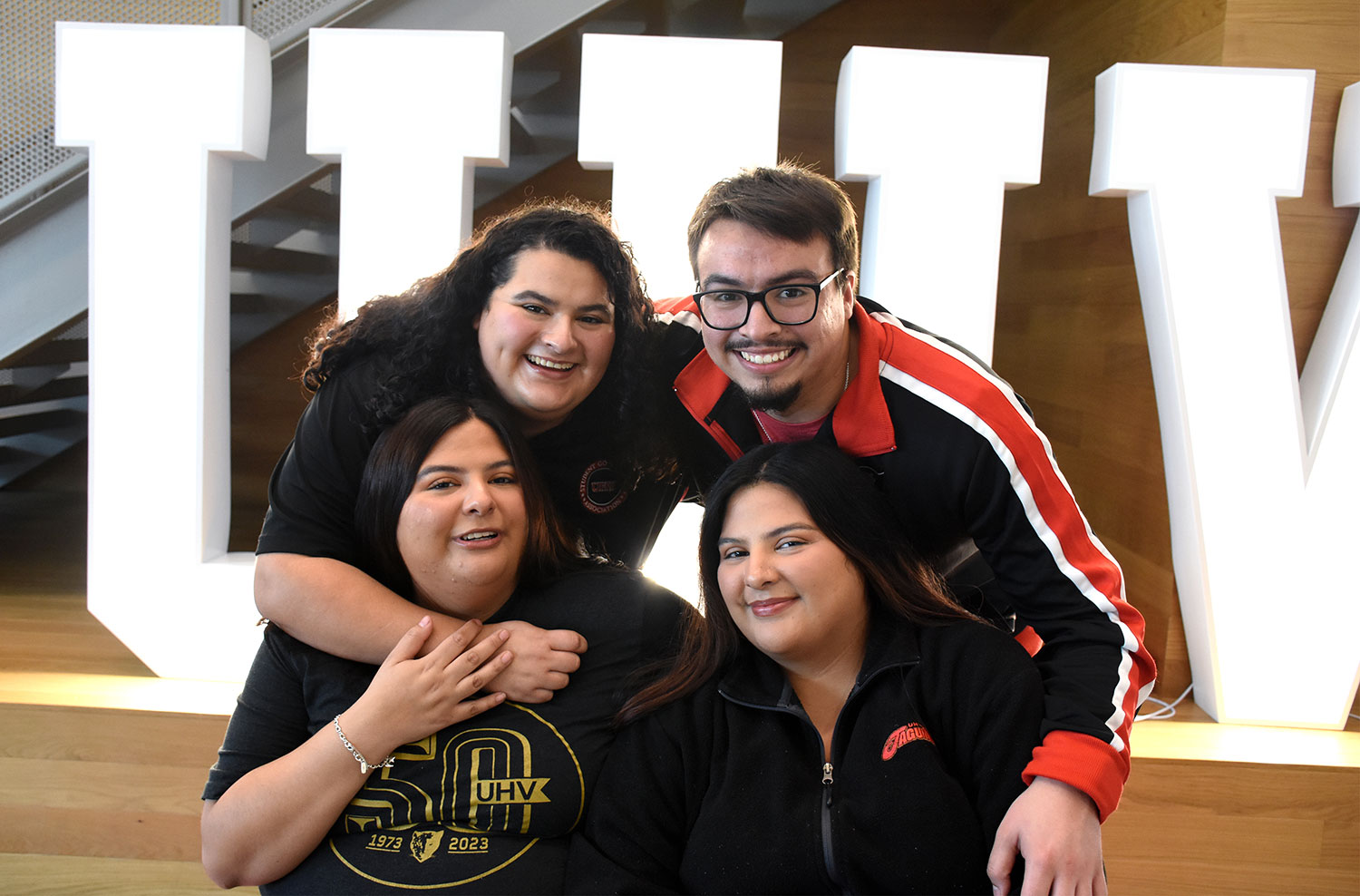 Four UHV siblings pose fo a group photo