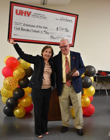 Employee of the Year Connie Rodriguez and UHV President Bob Glenn pose together for picture.