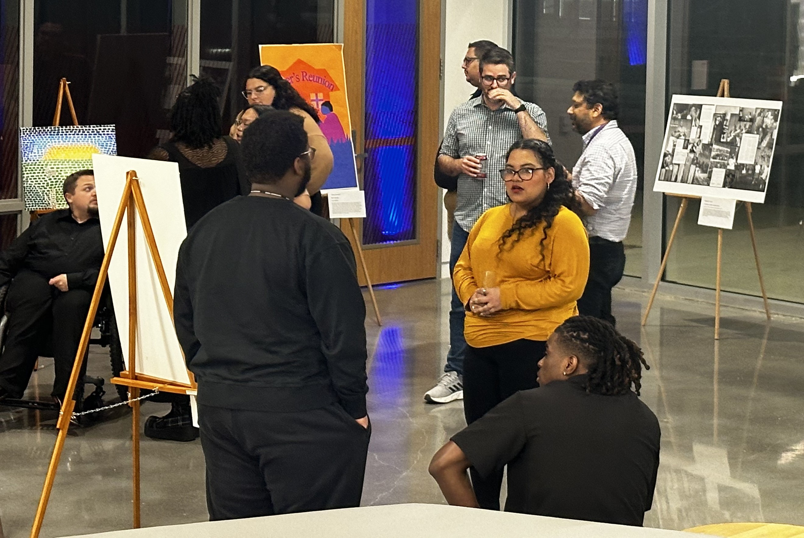 People look at artwork in a room