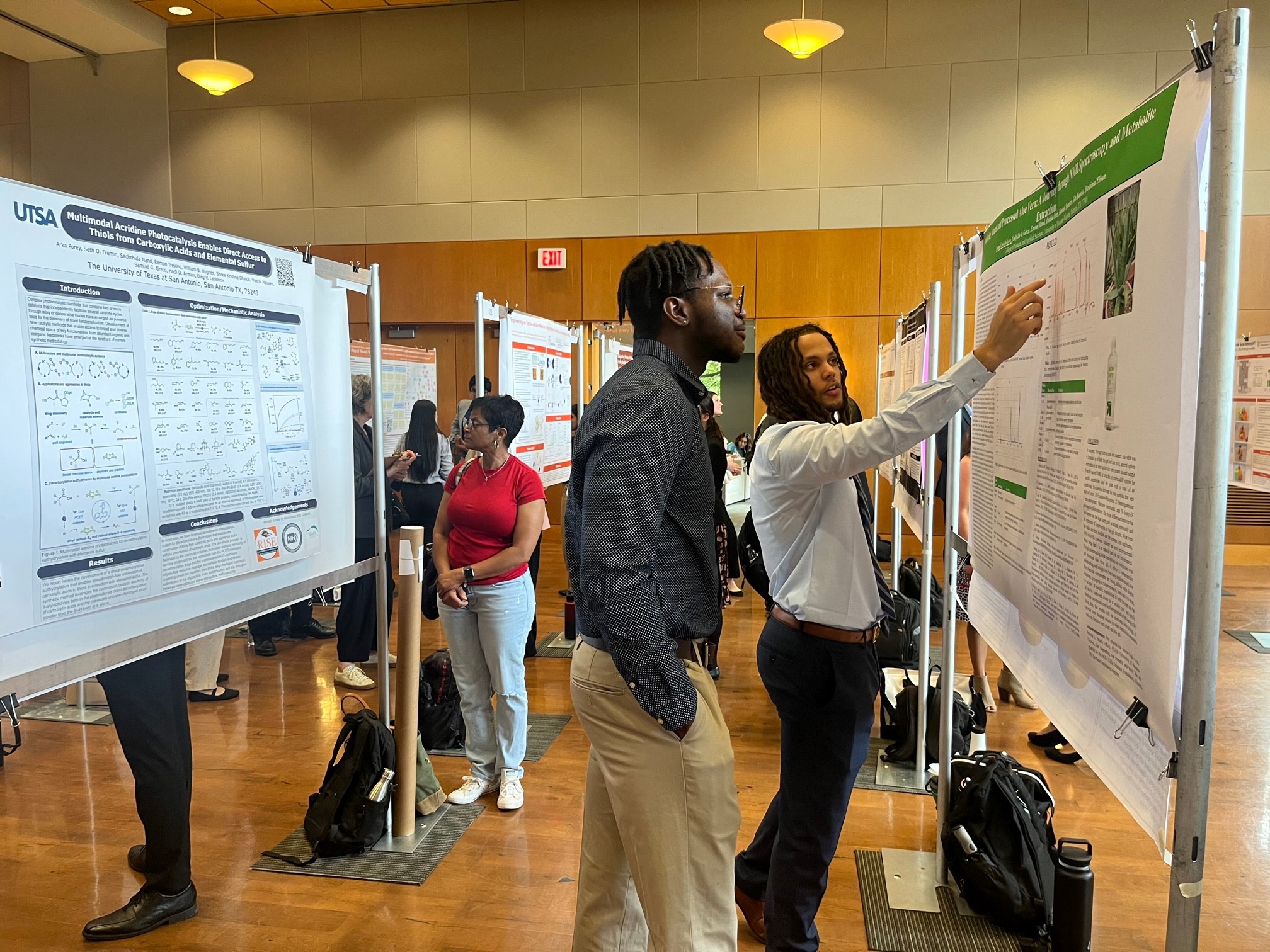 Two students look at a poster of genetics research