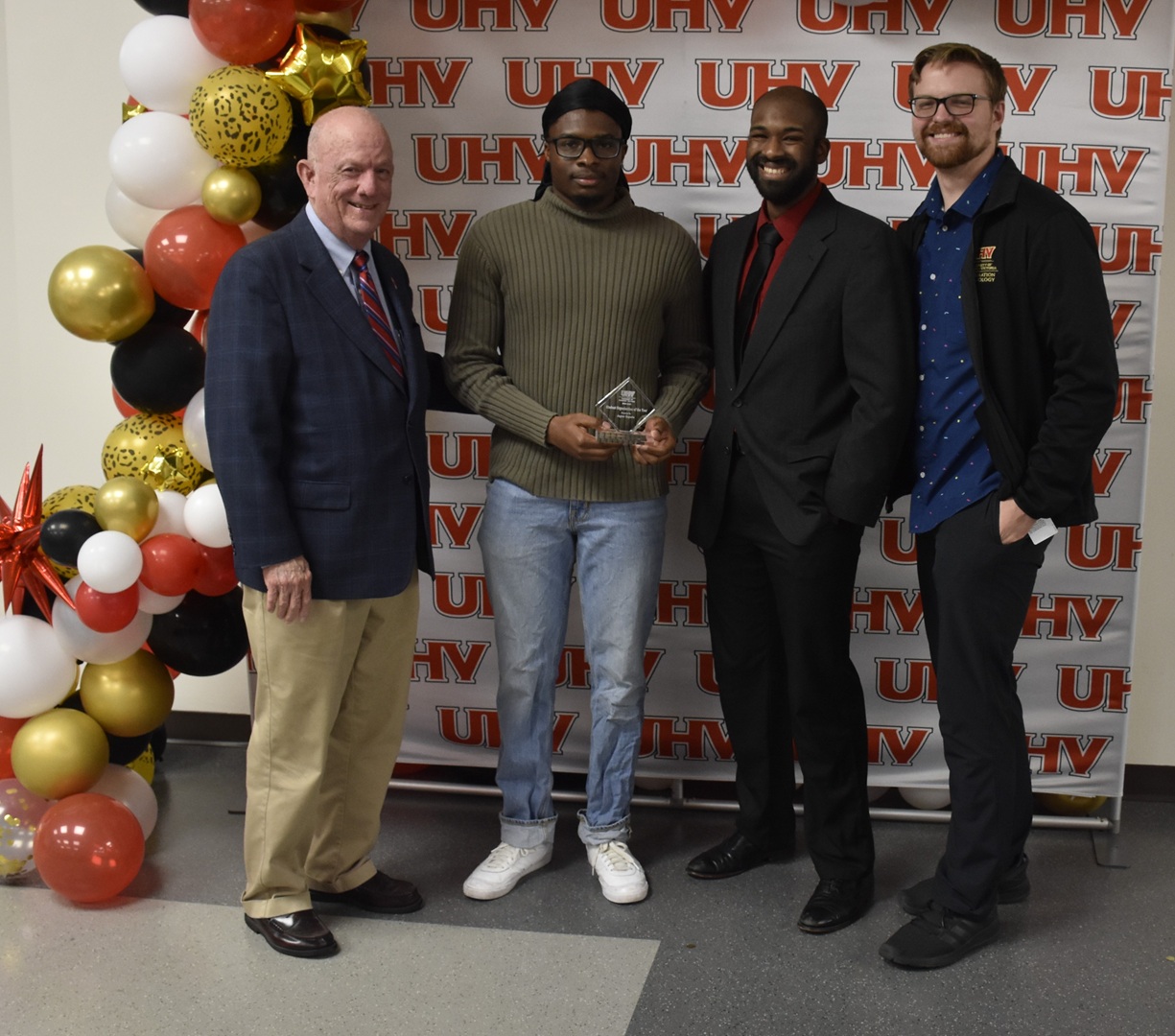 Members of Jaguar Esports accept their award from UHV President Bob Glenn.