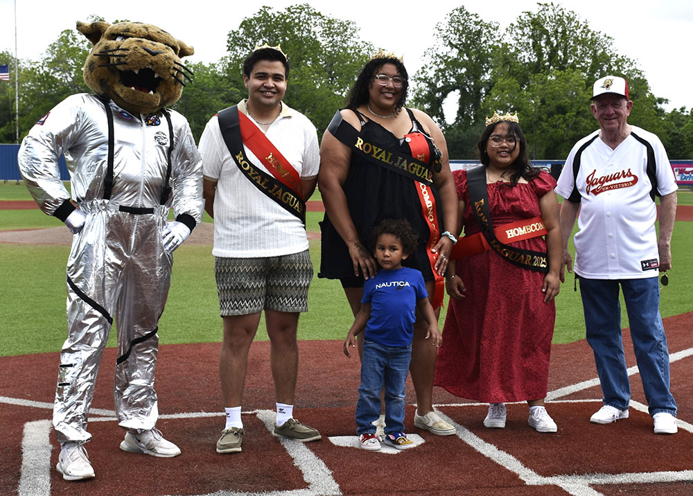 The three winners of the UHV Royal Jaguars stand with UHV President Bob Glenn and jaX, the UHV mascot.