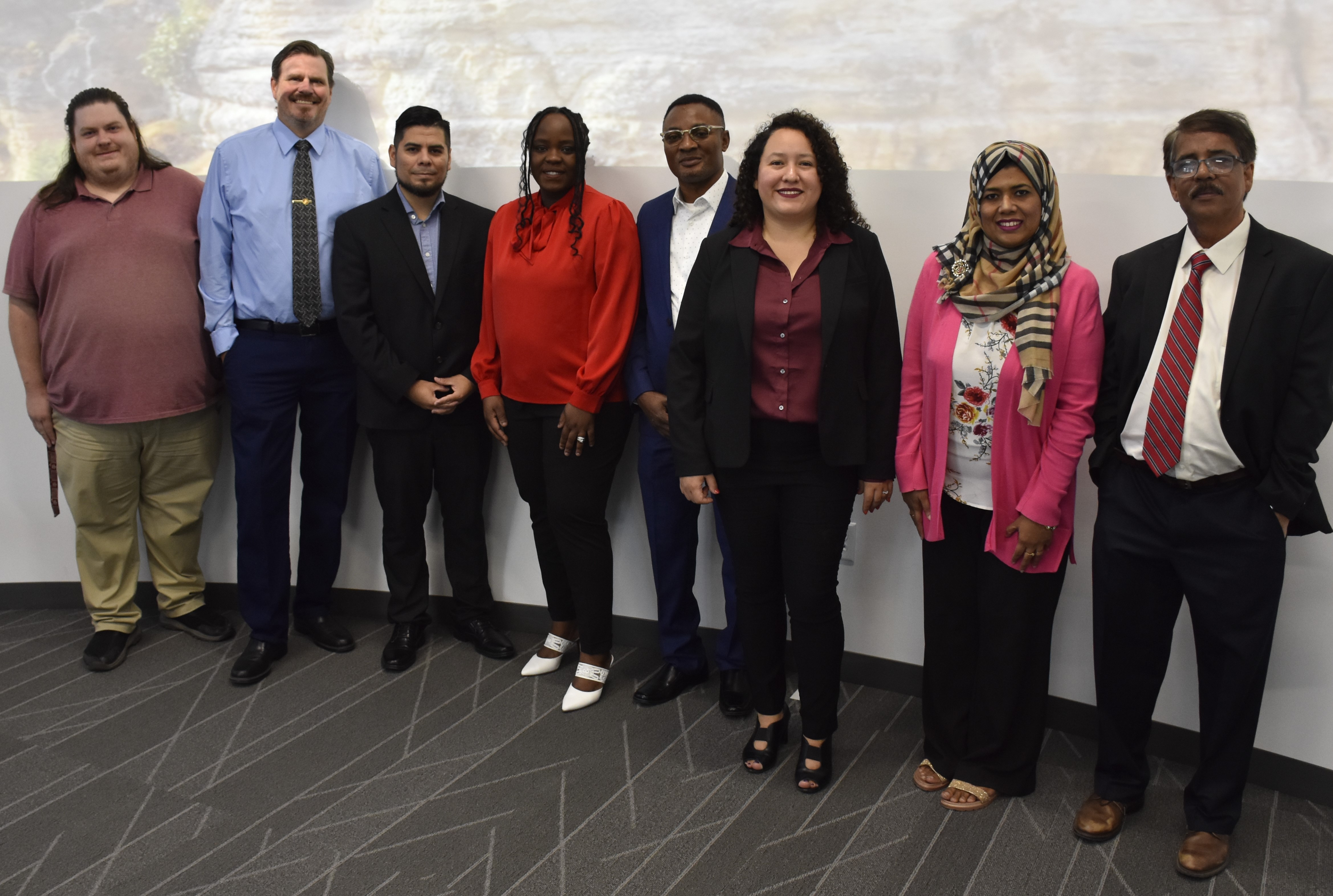 A group of students and faculty members pose for a picture.