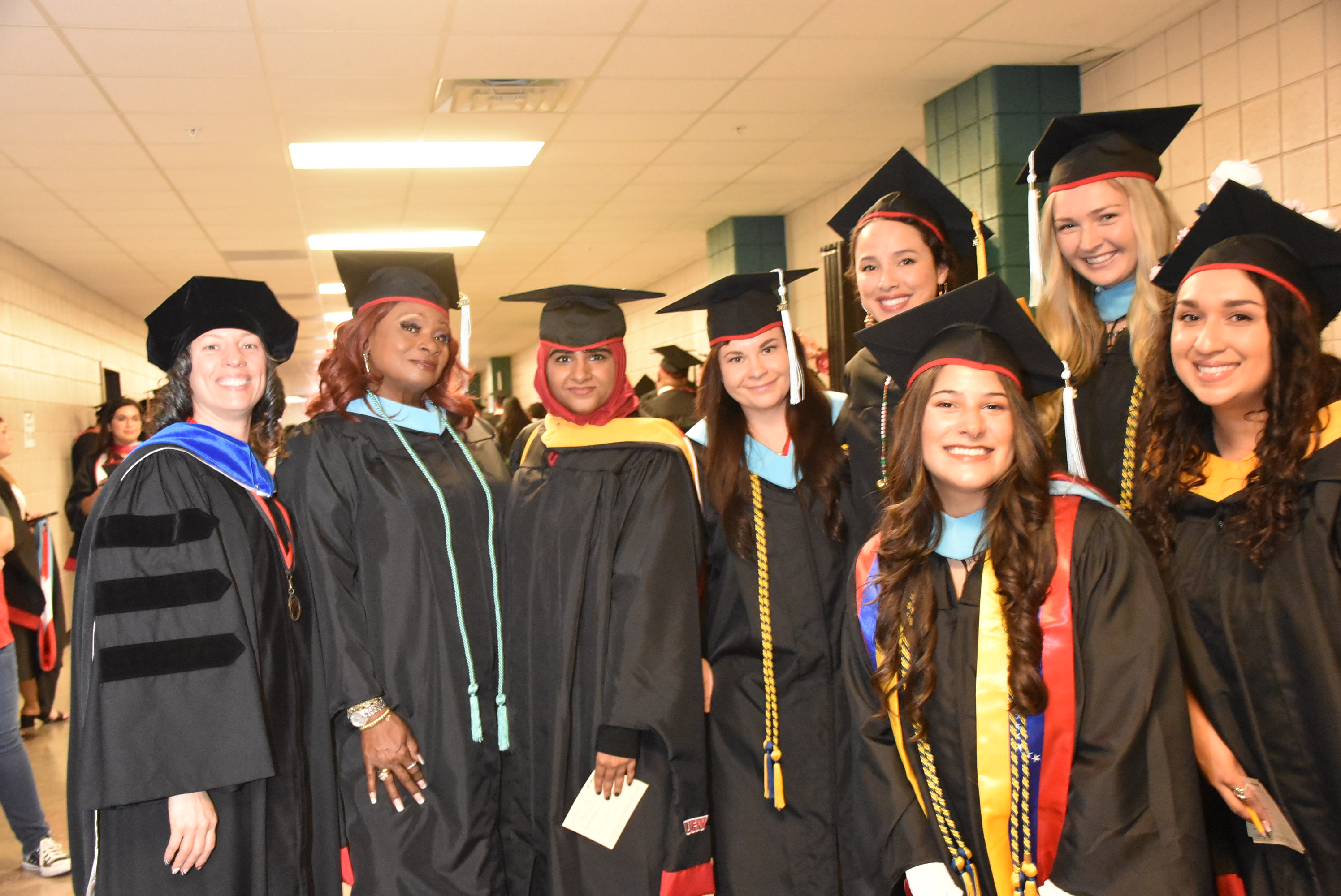 Photo of a group of recent UHV graduates in their caps and gowns.