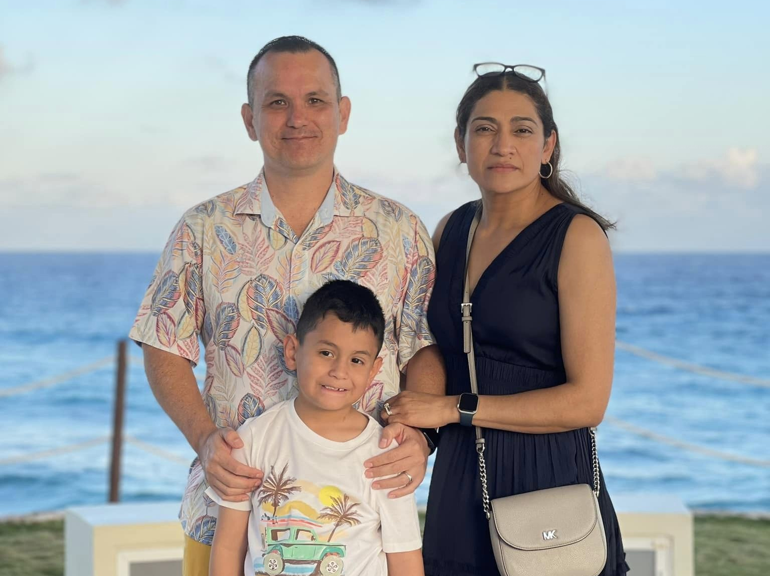 Dante Capella stands with his wife Erica Capella and their seven-year-old son. Capella, along with Nicole DeLoach of Houston, has achieved the Top 100 ranking list four weeks in a row in the Global Business Simulation competition.
