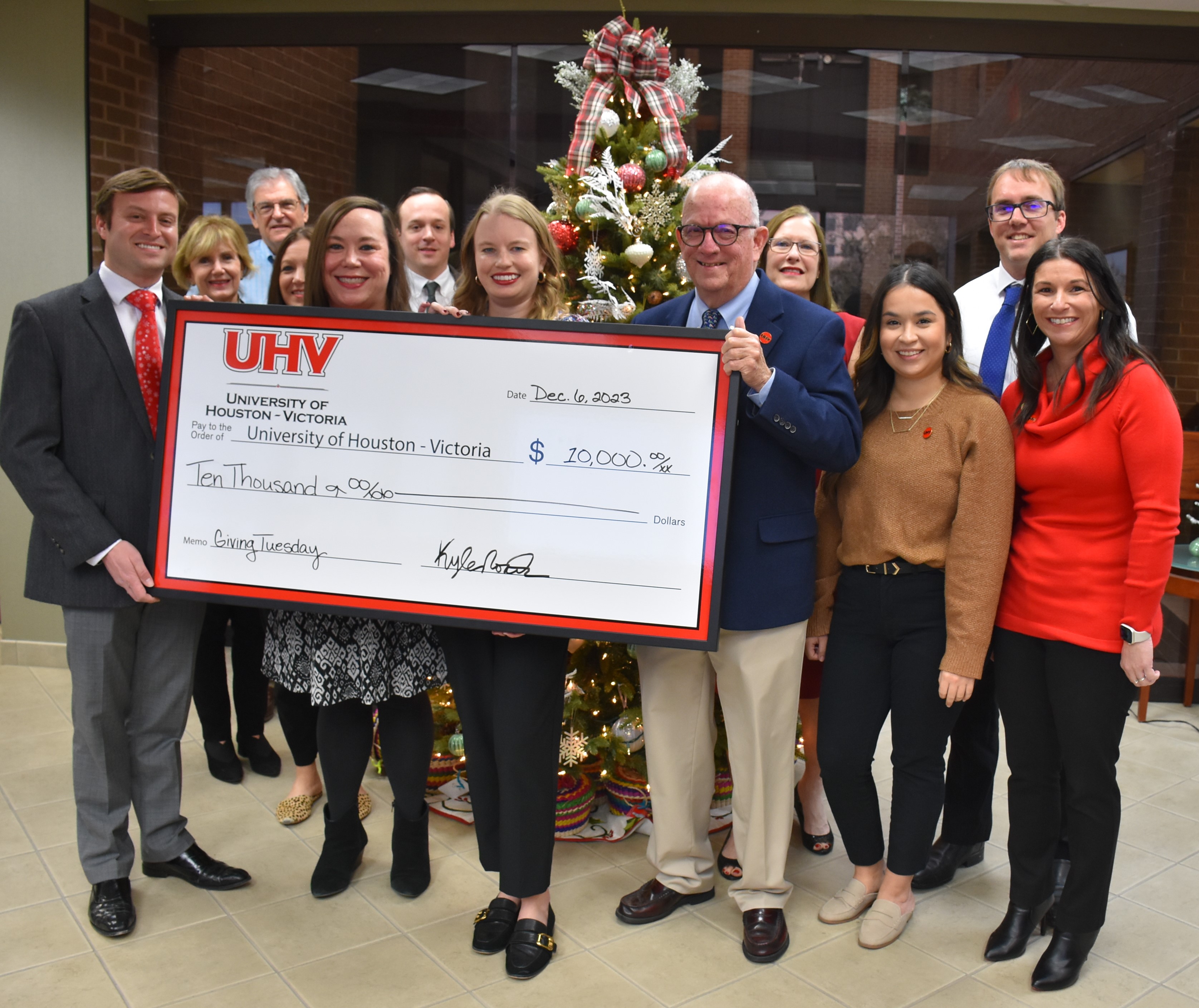 People pose with a big check