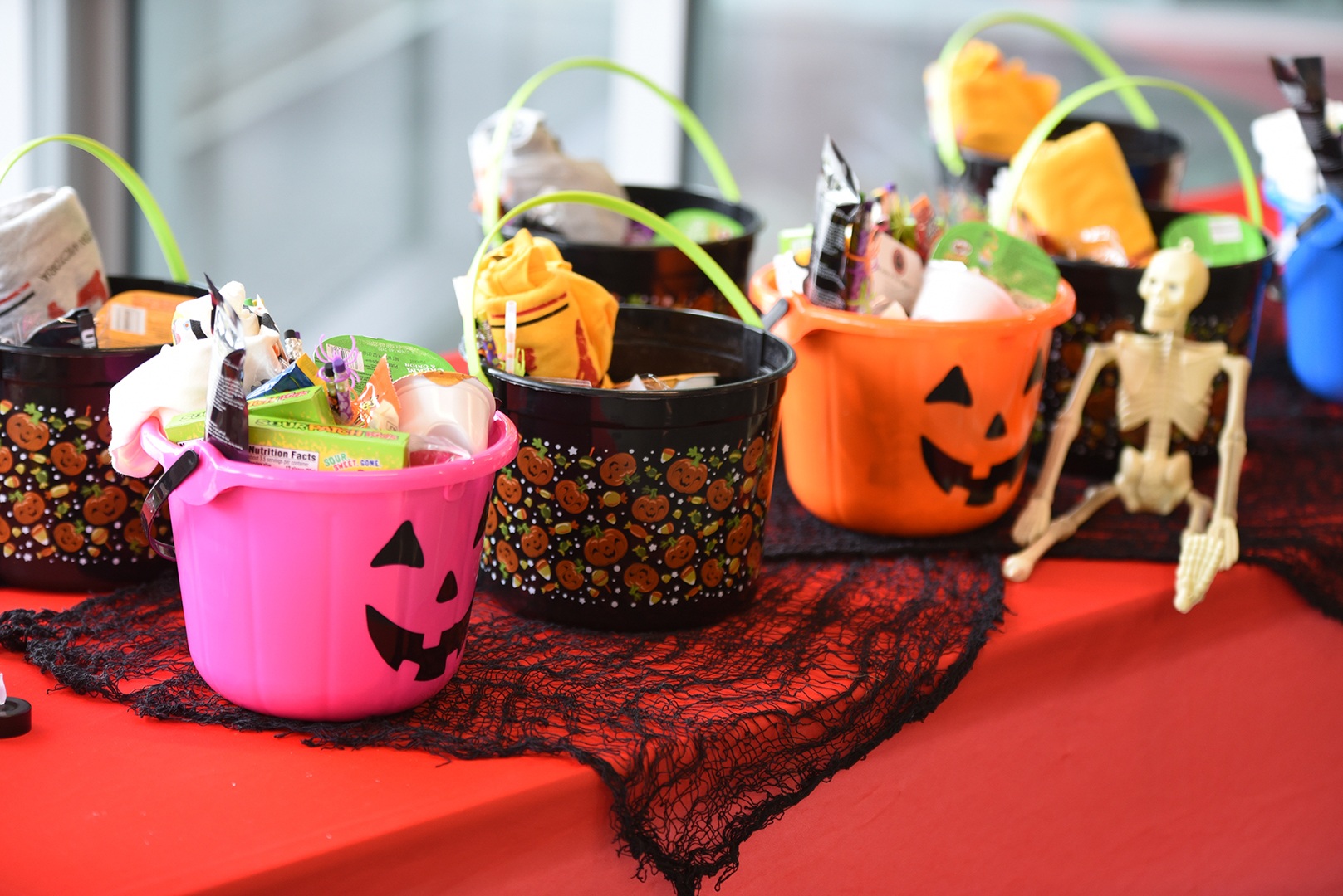 Halloween pumpkin buckets filled with themed candy