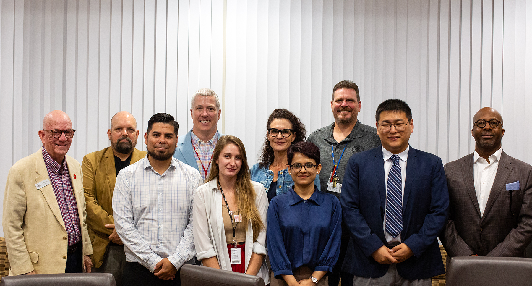New faculty members pose for a photo with UHV administrators and current faculty members.