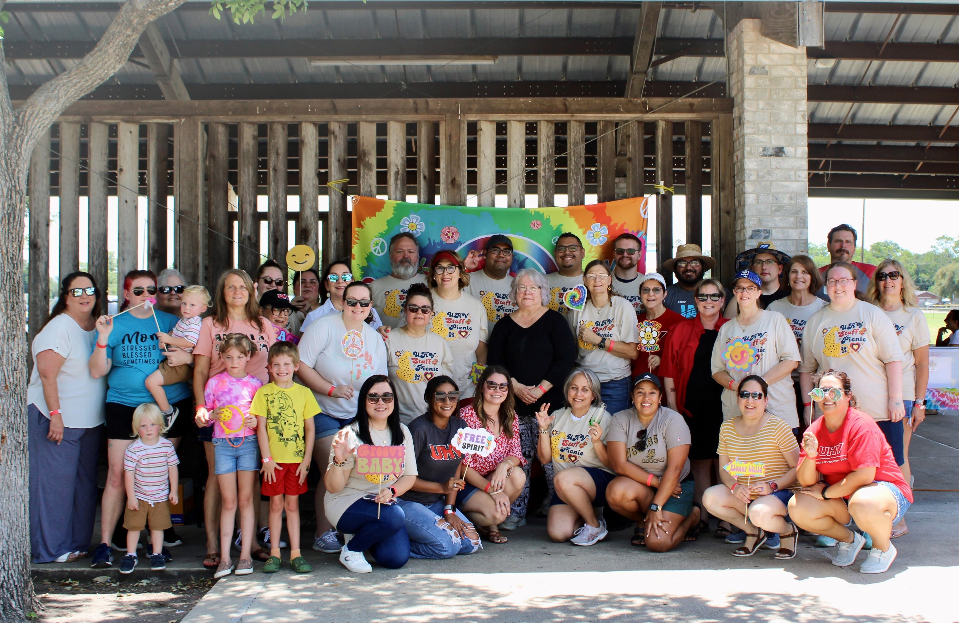 A large group of UHV staff members pose for a photo.