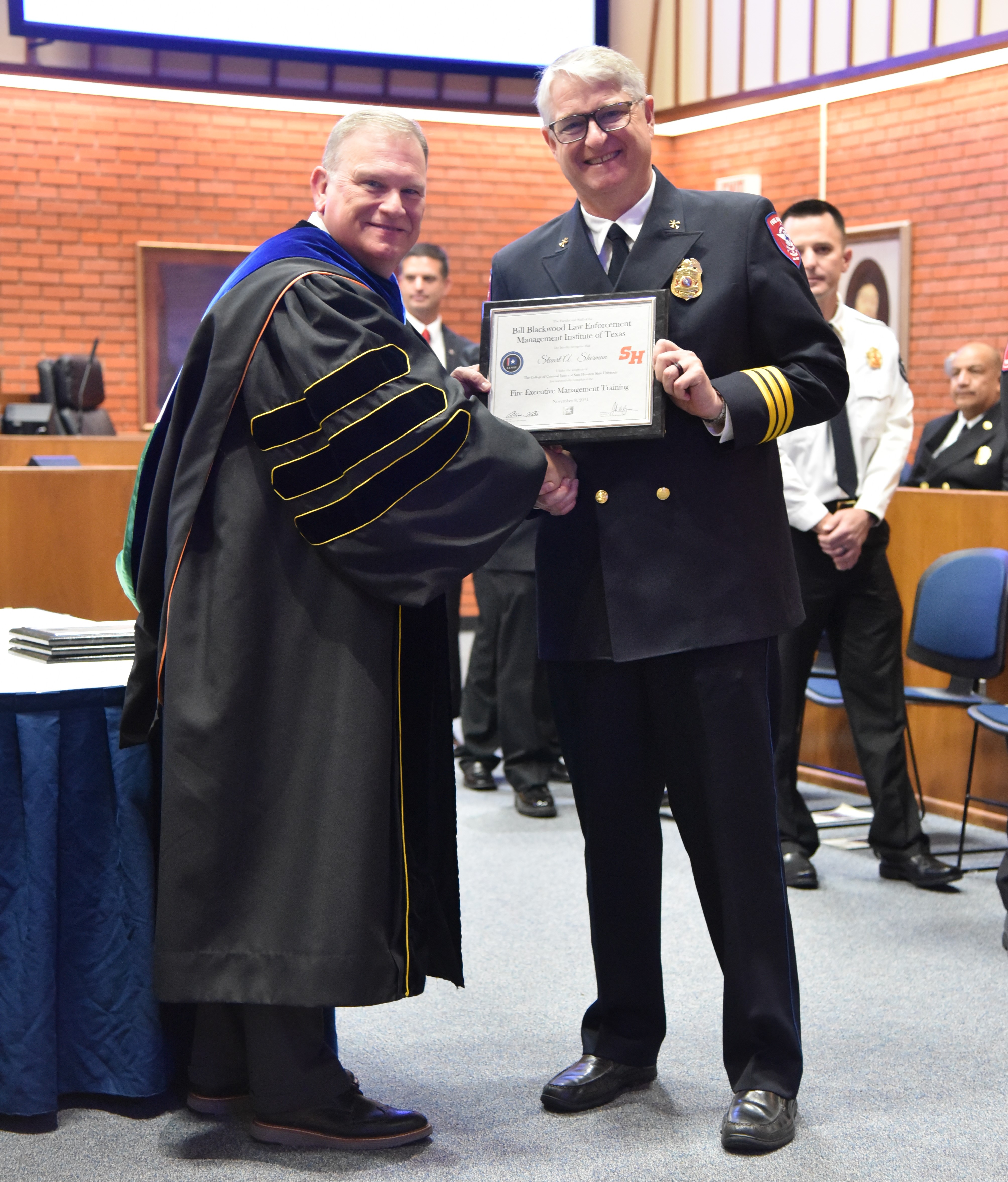 Stuart Sherman receives his graduation certificate.
