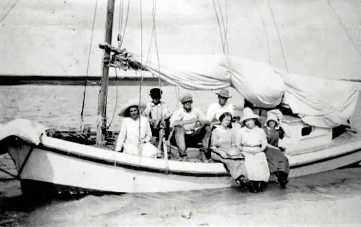 A group of people posing on a boat
