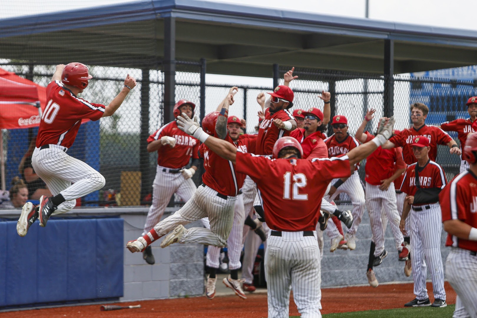 The UHV baseball team celebrates Hal Perez's first-inning grand slam during Tuesday's Red River Athletic Conference championship game against LSU-Alexandria. The Jaguars won the game 12-2 to win UHV’s first RRAC baseball title.