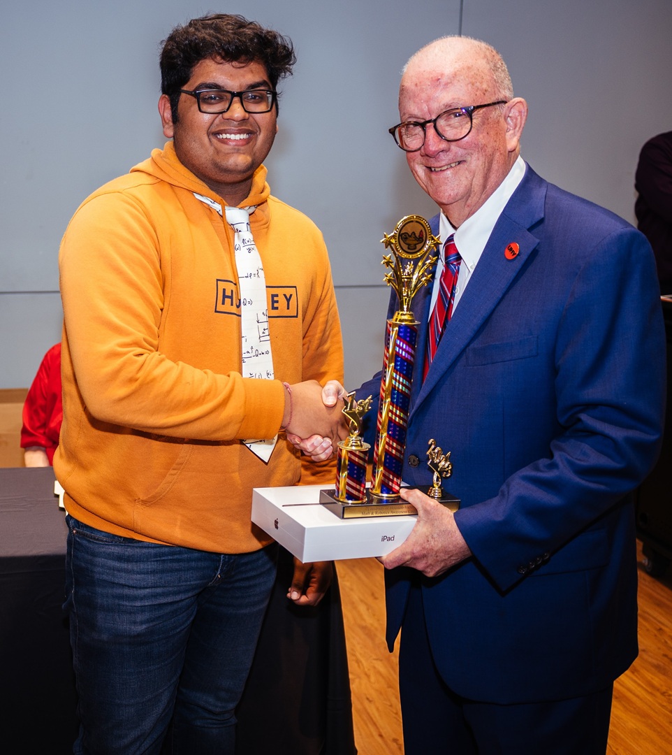 Sanchit Singhal shakes hands with President Bob Glenn.