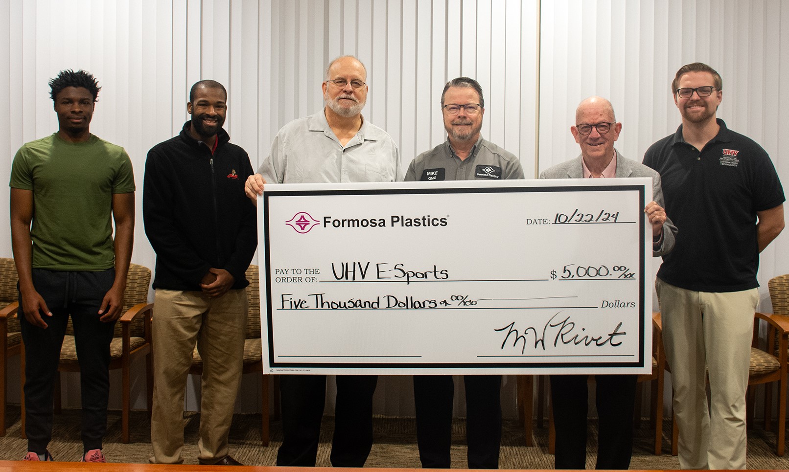 Formosa executives hold up a huge check for UHV Esports