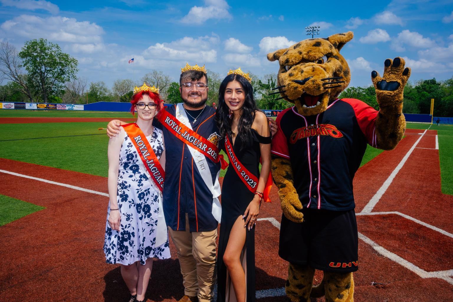 Three UHV students, each wearing a crown and a sash that says 