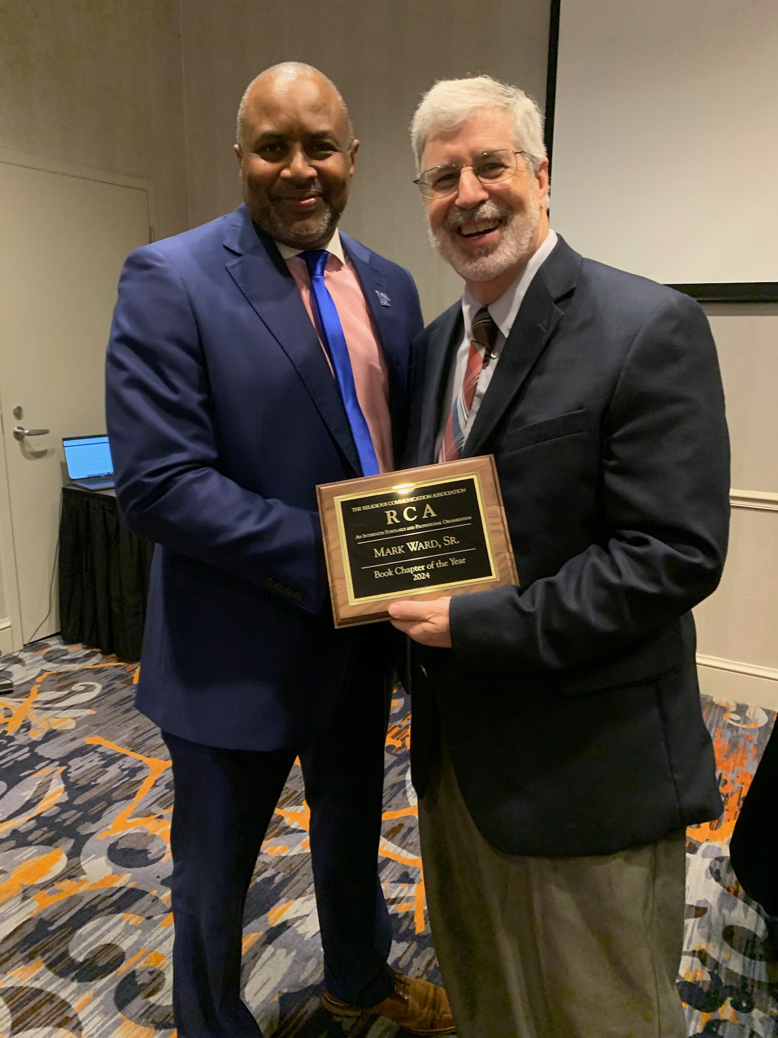 Mark Ward received an award at a conference.